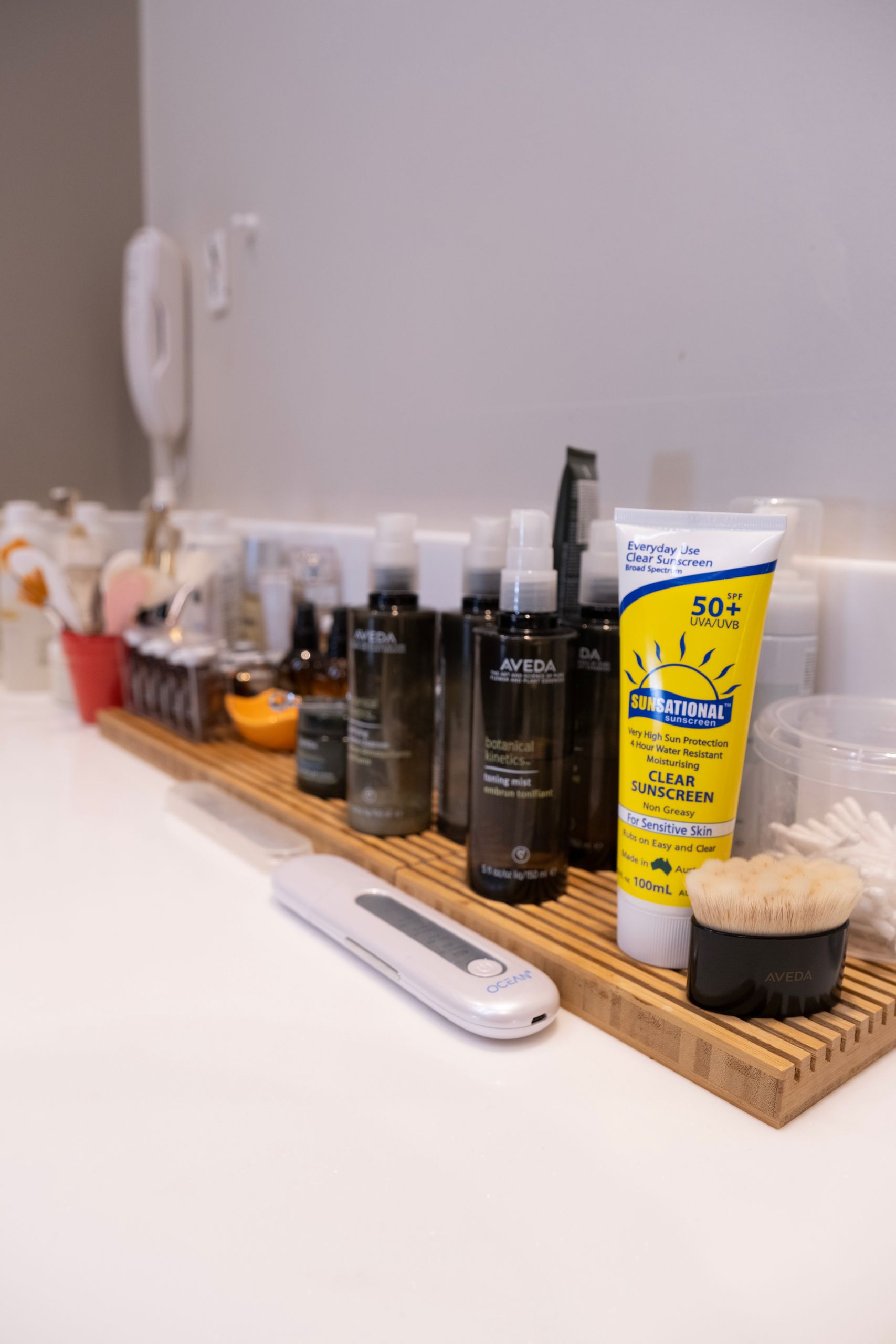 A neatly arranged bathroom shelf showcasing various skincare products and accessories.