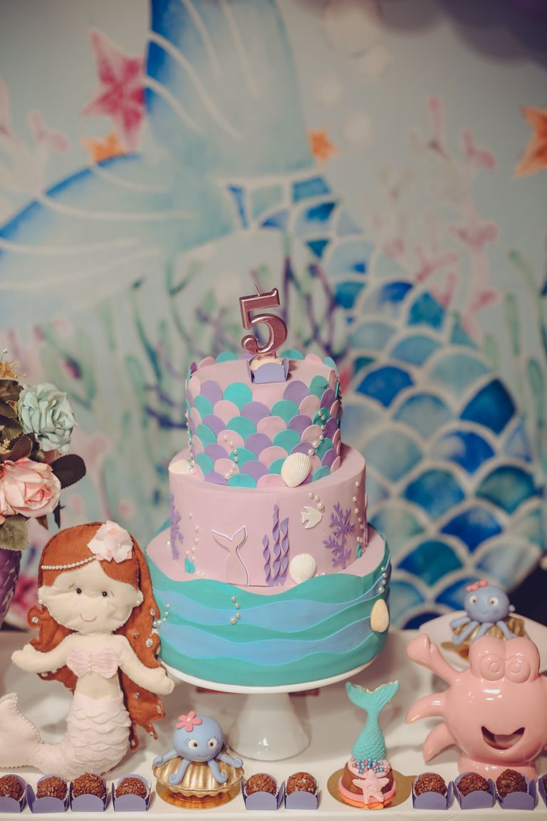 A vibrant mermaid-themed birthday cake with oceanic decorations perfect for a 5th birthday.