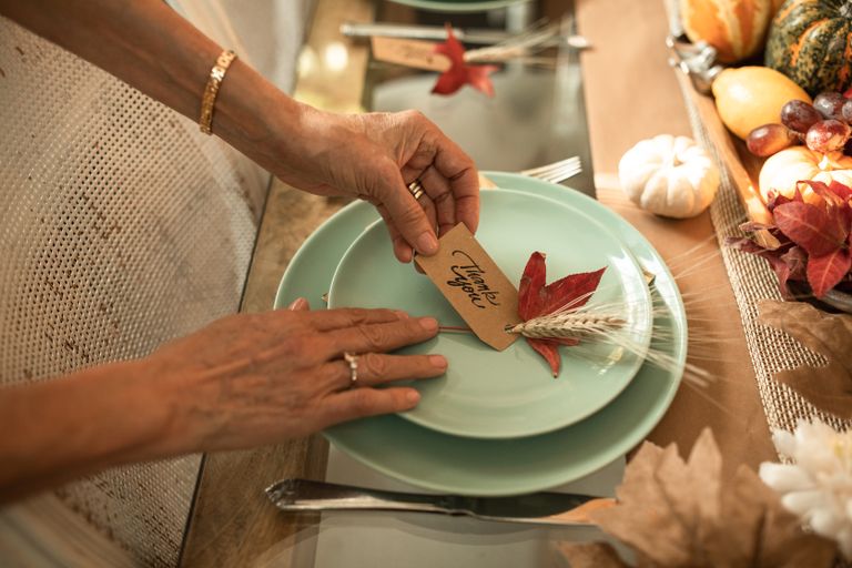 Beautiful autumn-themed table setting with a 'Thank You' card, perfect for Thanksgiving celebrations.