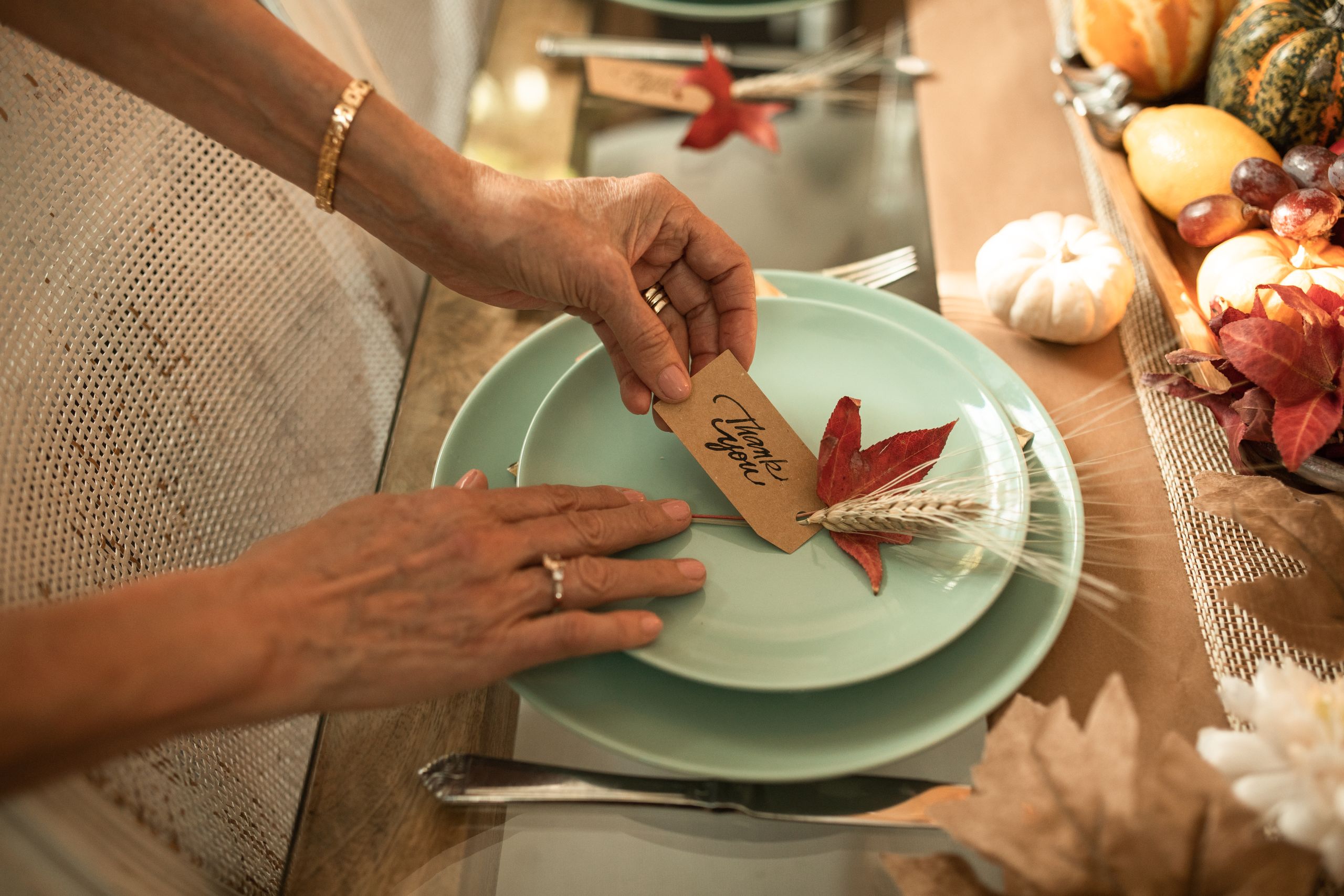 Beautiful autumn-themed table setting with a 'Thank You' card, perfect for Thanksgiving celebrations.