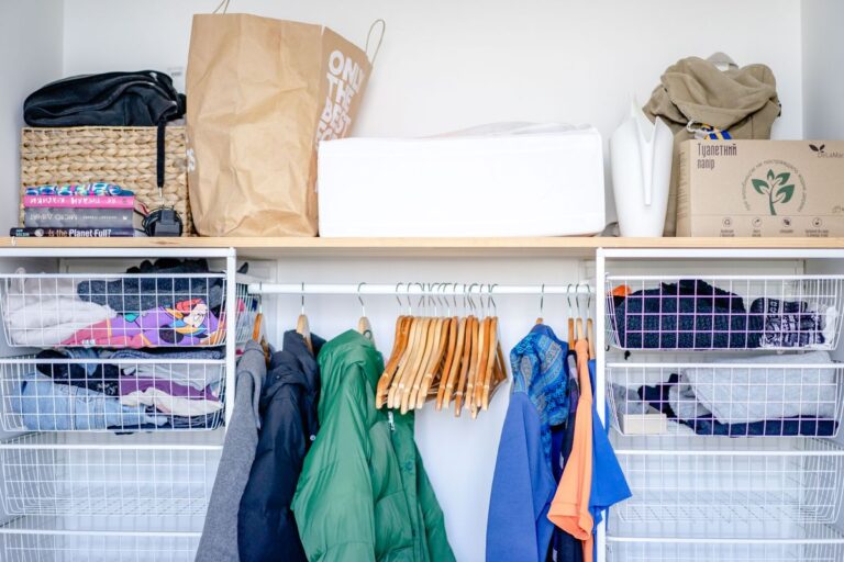 Minimalist open wardrobe rail with hangers and storage baskets, one of my favorite clothes storage ideas for small spaces