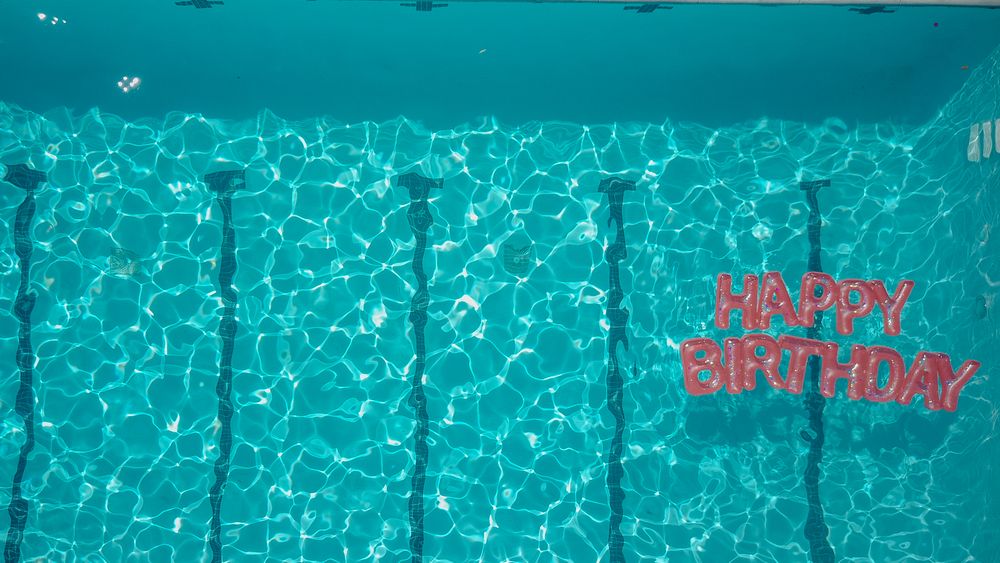 Top view of a swimming pool with a 'Happy Birthday' message, perfect for festive occasions. Stock Photo.