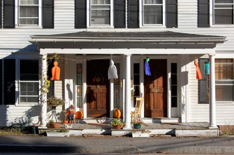 Cozy porch decorated with festive Halloween decorations and vibrant colors. Stock Photo.