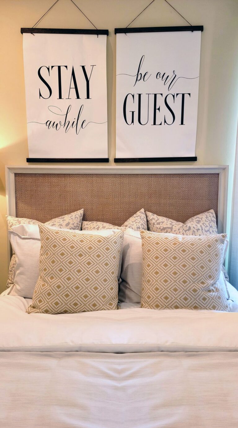 Inviting bedroom with cushions and artwork, creating a cozy atmosphere. Stock Photo.
