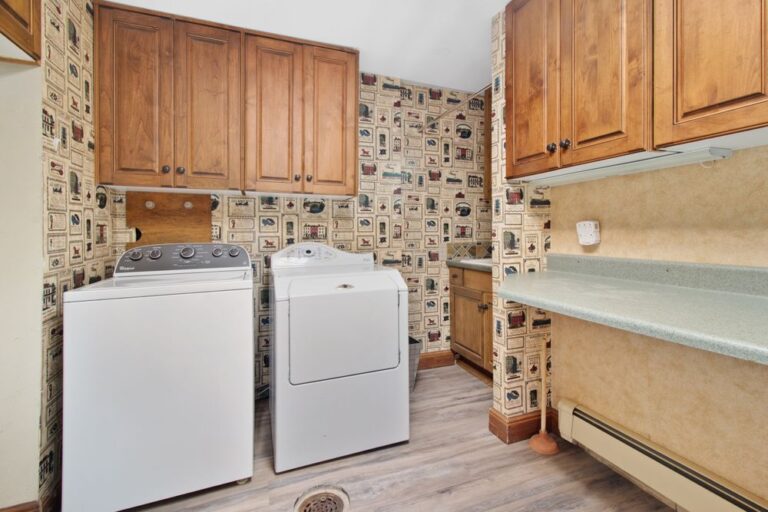 Cozy laundry room with wooden cabinets and washer and dryer, perfect for built-in basket cubbies