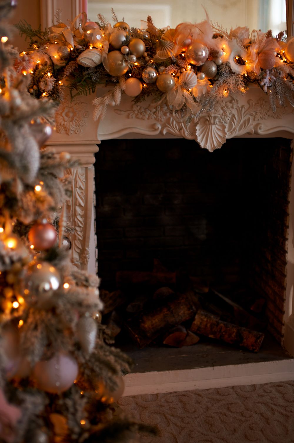 Cozy Christmas fireplace adorned with festive garland and ornaments, glowing warmly. Stock Photo.