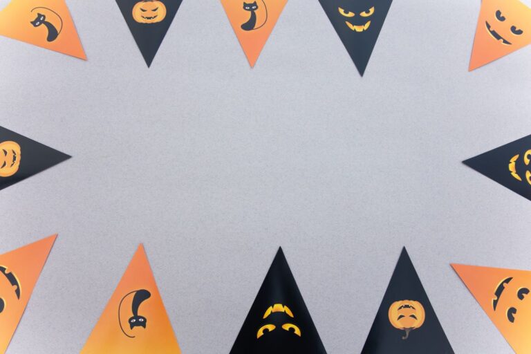 Orange and black Halloween bunting with festive icons strung across a wall