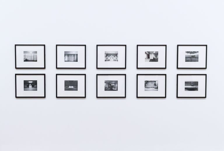 Simple and elegant wall display with black and white framed photographs in a modern interior.