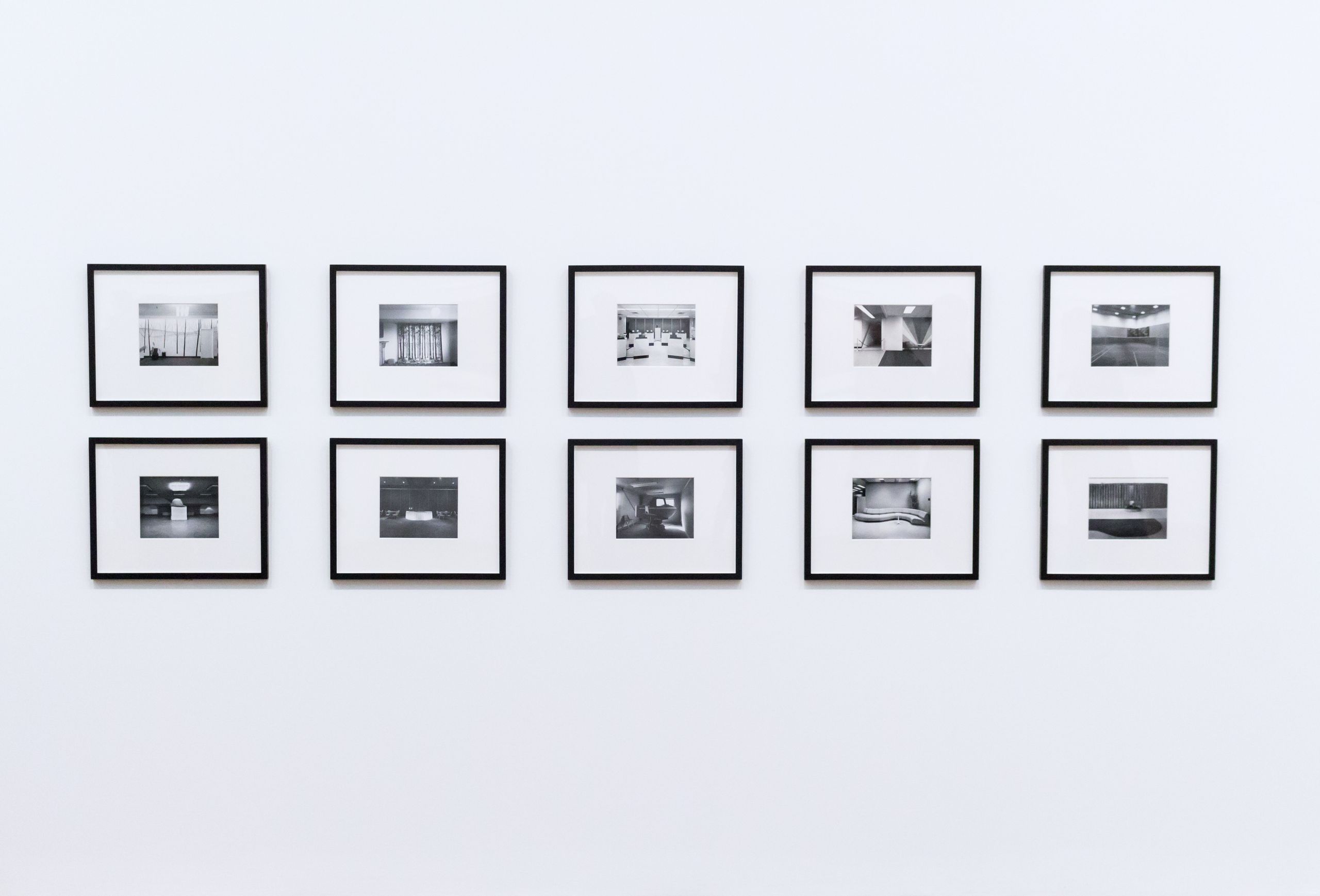 Simple and elegant wall display with black and white framed photographs in a modern interior.